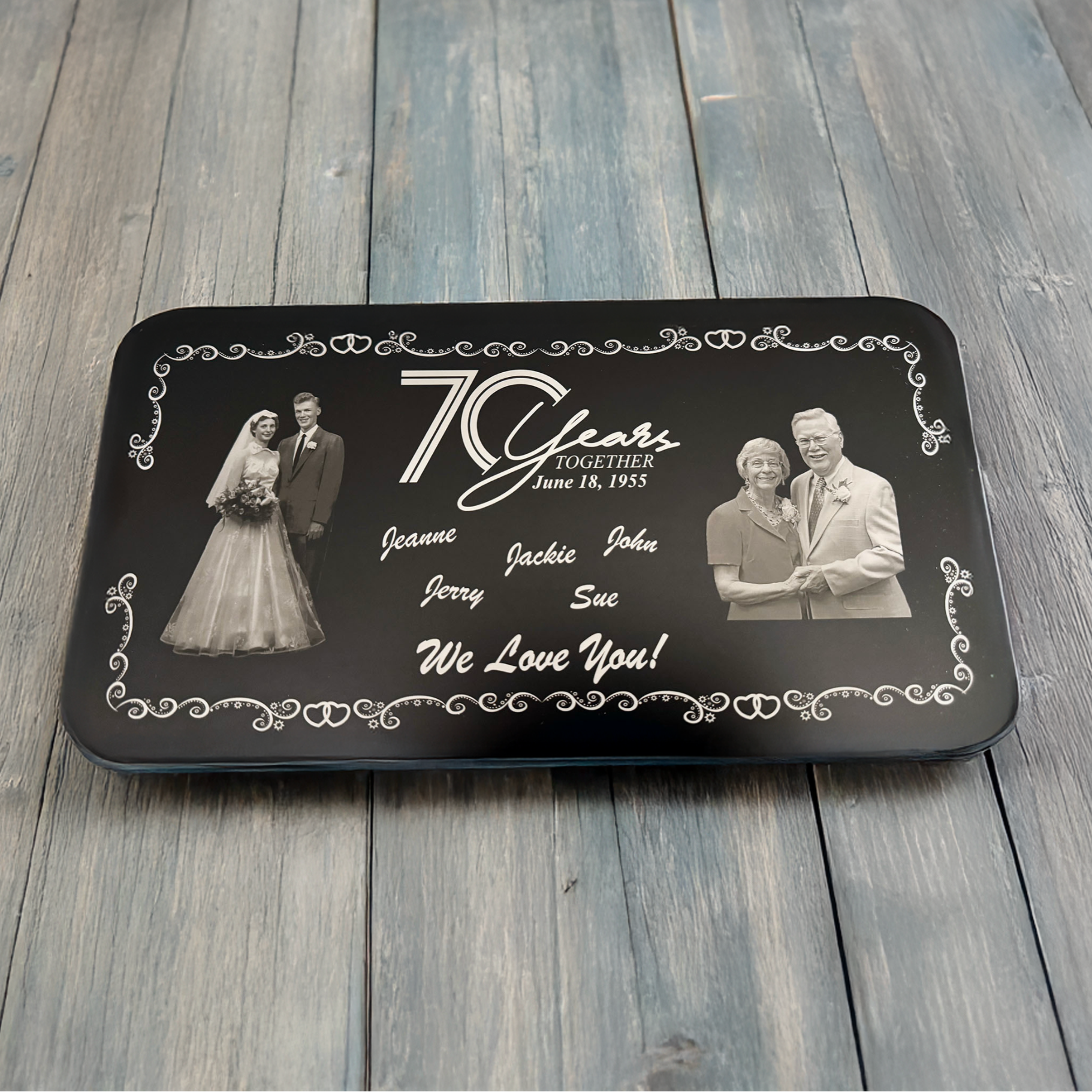 Personalized 70th anniversary gift with black border and white text on a wooden surface